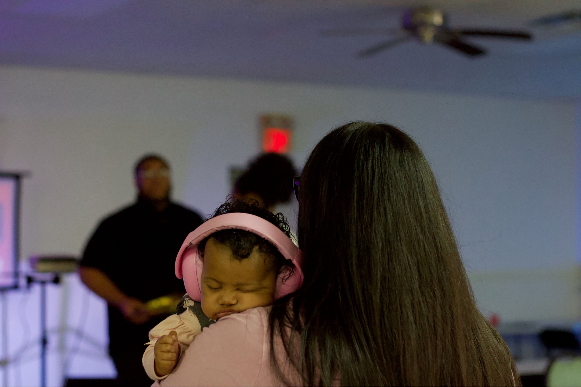 Mother holding baby during worship at The Connection Church